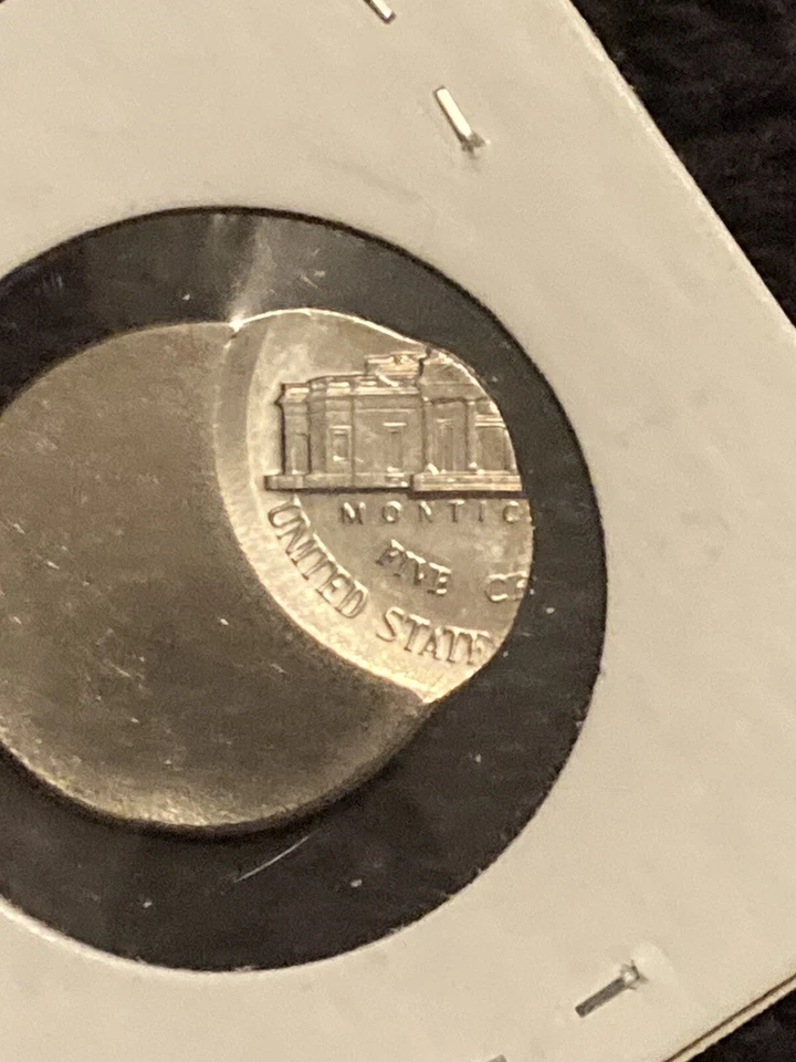 1947 Jefferson nickel off-center strike error showing blank crescent of exposed planchet with full 1947 date visible on shifted design