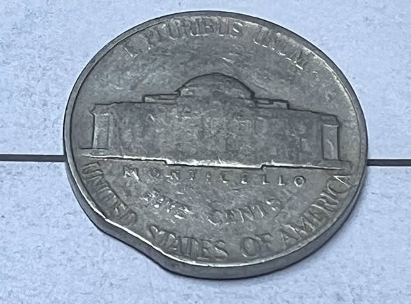 1947 Jefferson nickel clipped planchet error showing smooth curved missing piece at coin edge with Blakesley Effect rim weakness opposite